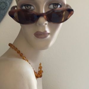Judith Leiber cat eye sunglasses with crystal temples.